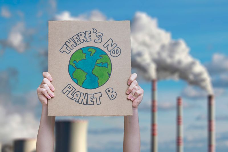 Climate change manifestation poster "There is no planet b" on an industrial fossil fuel burning