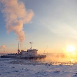 Ice Breaker ships breaks Ice at Sunset over the Arctic OCean