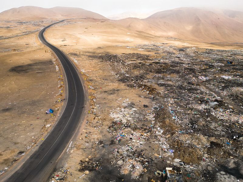 Old clothes discarded in the Atacama Desert, imported from Europe, Asia and the USA. Residents of the nearby town of Alto Hospicio, Iquique collect textiles from the mountains of trash and sell the used clothing at the local market. The rest is thrown away and burned. 