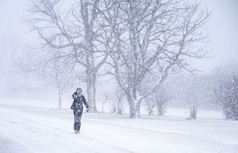 Woman walks through snowstorm in Buffalo, New York