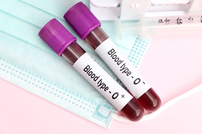 An image of two blood samples on a medical mask laying on a table. The test samples are labelled Blood type - O positive and Blood type O negative. 