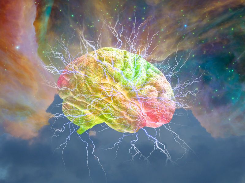 brain emitting electricity shown on multicolored pastel background