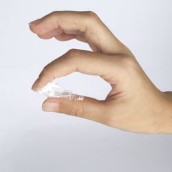 Sticky gel between finger. Vaginal discharge between fingers. Hand. White background. 