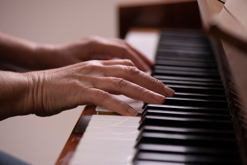 close up of hands playing the piano