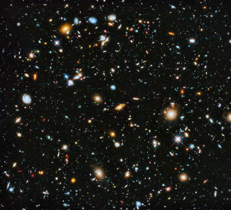 Astronomers using Hubble assembled the most comprehensive picture of the evolving universe. Tiny red dots — early, shapeless galaxy building blocks whose light has been stretched by the expanding universe into an infrared glow — litter the most distant parts of the visible universe. Closer in, we see numerous galaxy interactions and collisions as galaxies come together and merge, growing in the process. Nearer still, we see the large, stately galaxies we know today