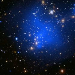  image of the Abell 2744 galaxy cluster combines X-rays from Chandra (diffuse blue emission) with optical light data from Hubble (red, green, and blue).