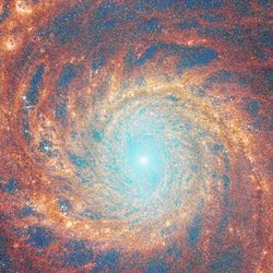 A composite image of the glorious "grand design" spiral galaxy M51, also known as the Whirlpool galaxy, by JWST’s NIRcam and MIRI instruments.