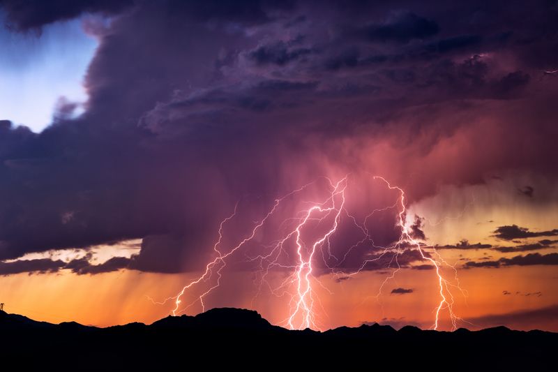 lightning against purple and orange cloudy sky