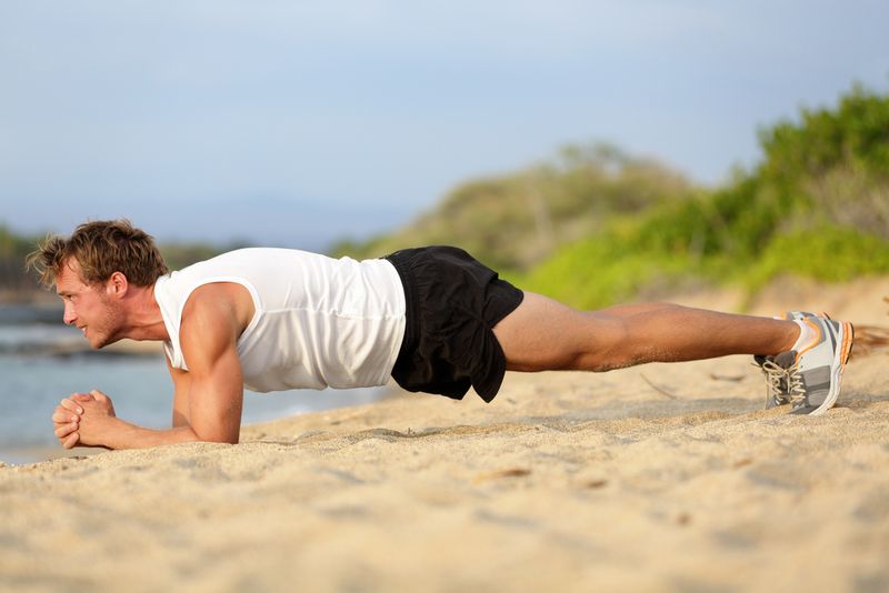 Man doing a plank on the beach