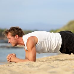 Man doing a plank on the beach