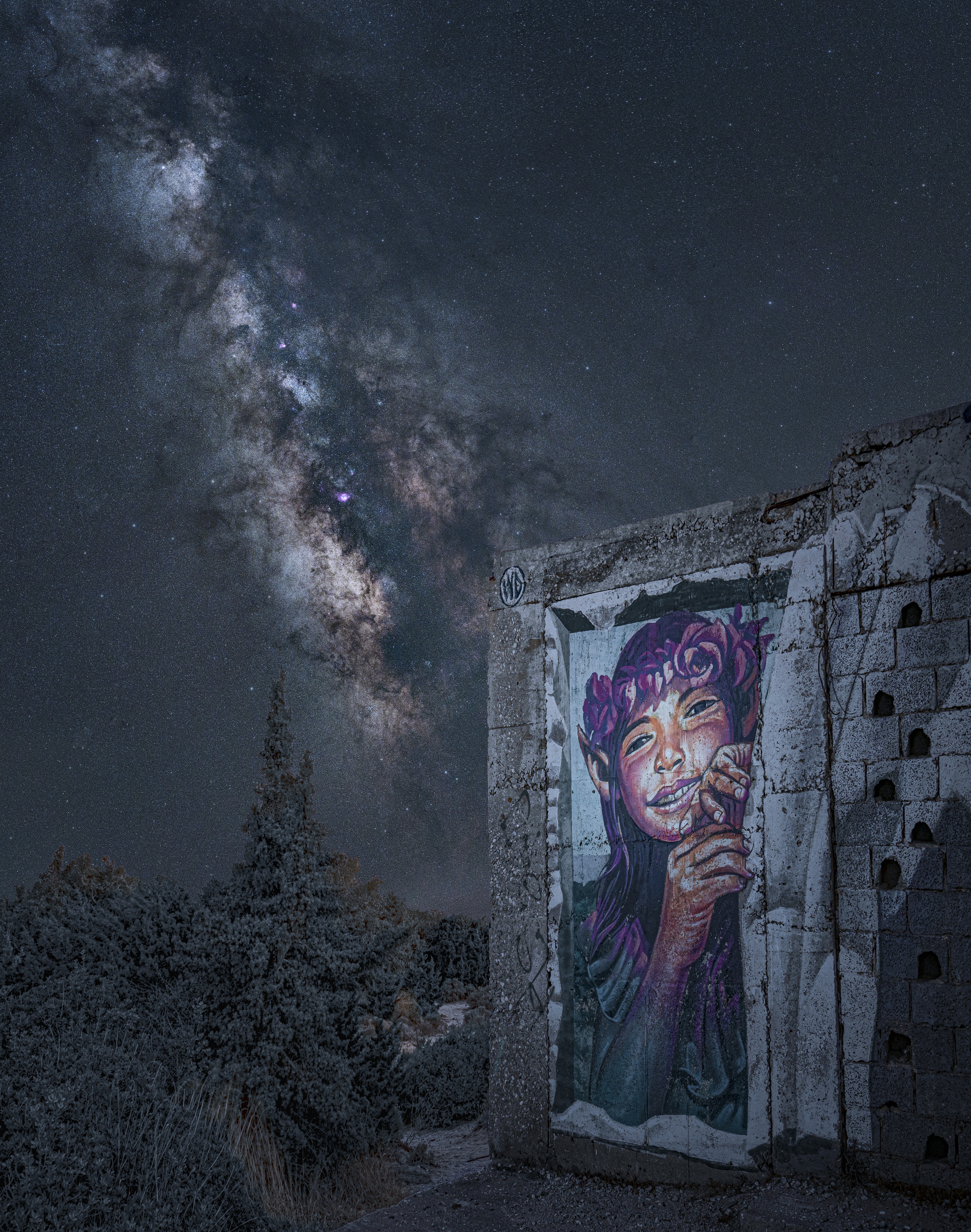 Pandora’s Box - The Milky Way viewed behind a graffiti of Pandora by Wild Drawing (WD) a Balinese artist on the Greek island of Naxos