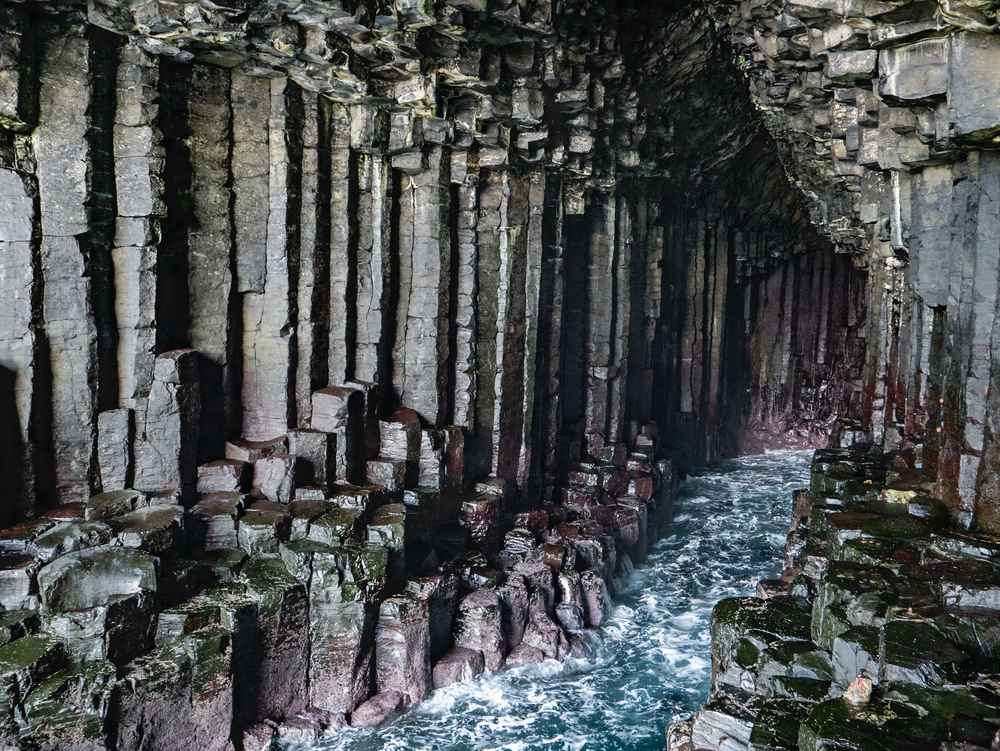 Unusual “columnar jointing" geology inside the sea cave of Fingal's Cave, Scotland.
