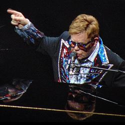 Sir Elton John singing and playing piano