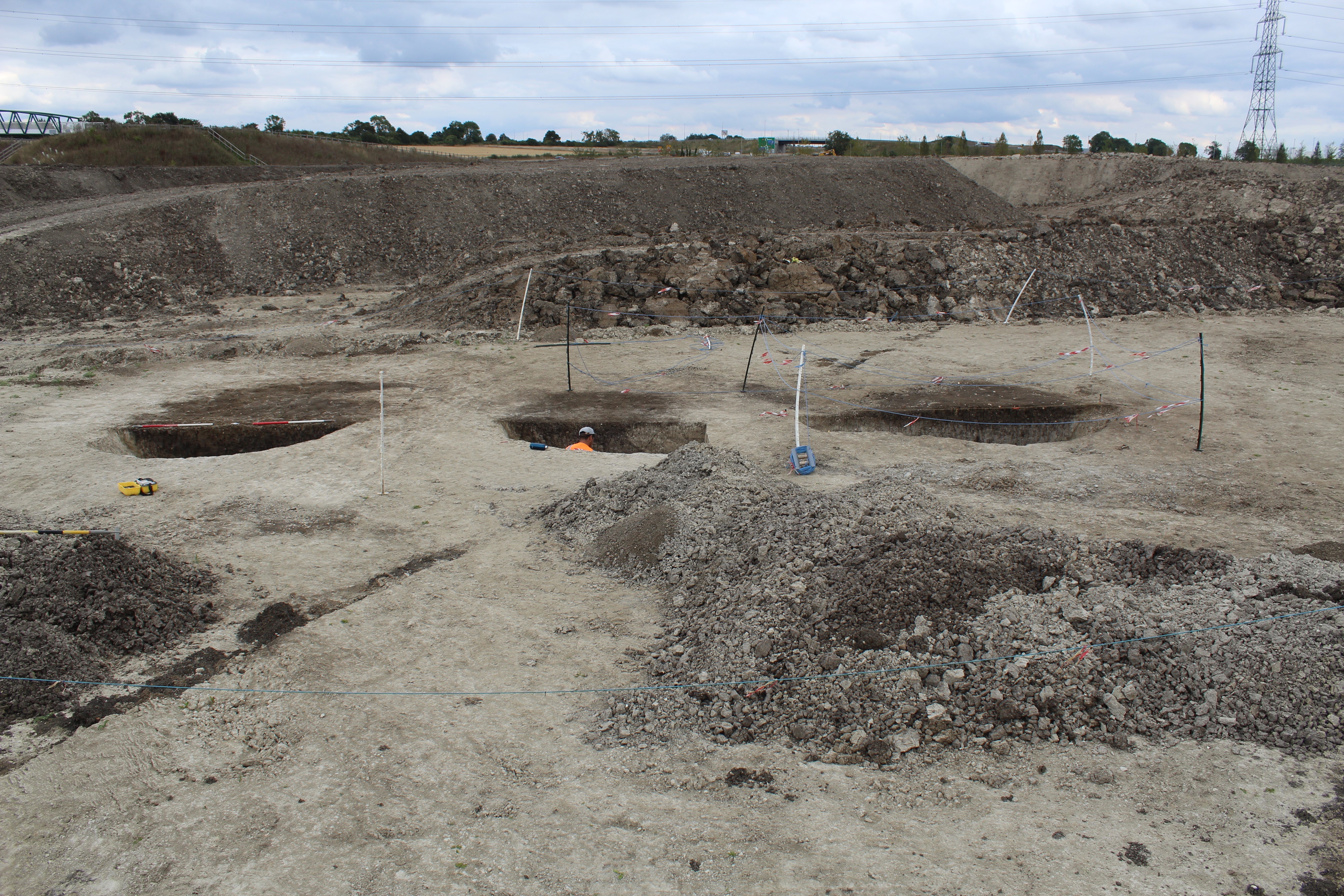 A photo of the excavation site in Bedfordshire, England, showing three pits