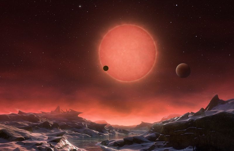 A brilliant artist's impression showing the view of red dwarf TRAPPIST-1 from the surface of one of its three Earth-like planets. 