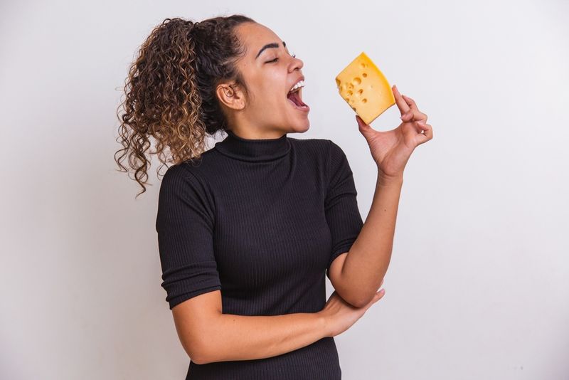 Woman eating a chunk of cheese