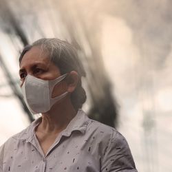 Woman wearing mask against air pollution