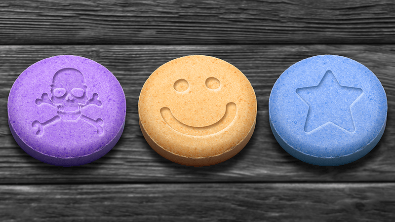 Three tablets, one with a smiley face embedded on the front.